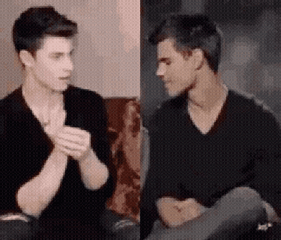 Two Young Men Talking On Couch GIF