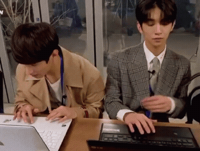Two Young Men Using Laptop GIF