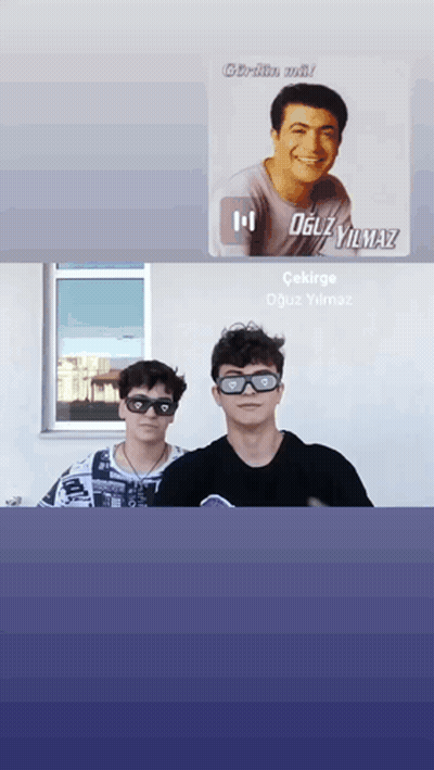 two young men wearing sunglasses are standing next to each other in front of a window with a picture of oguzyilmaz in th