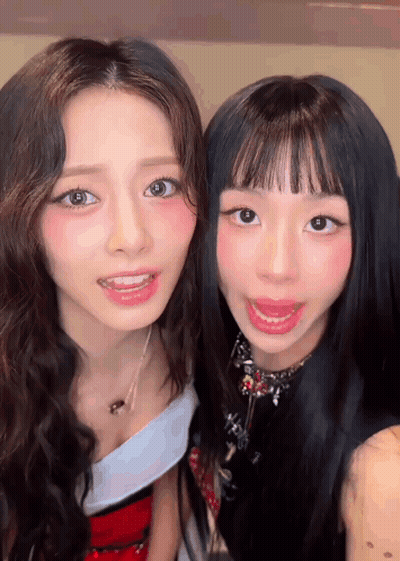 Two Young Women Are Posing For A Picture Together And Smiling For The Camera . GIF