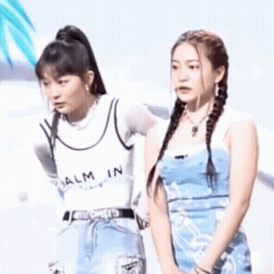 Two Young Women On Stage One Touching Other's Face GIF