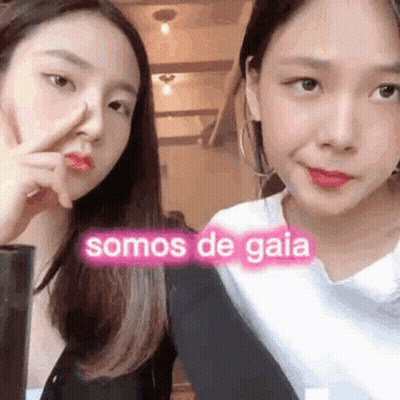 Two Young Women One Pointing At Nose GIF