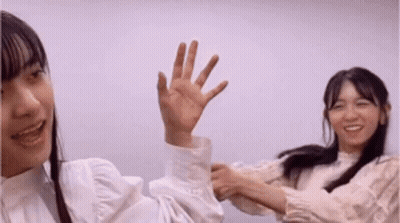 Two Young Women One Waving Hand GIF