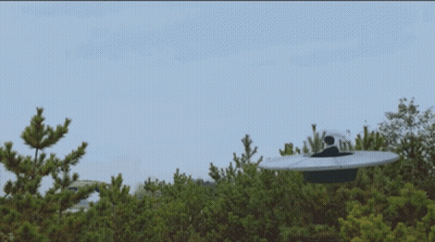 UFO Flying Over Forest With Blue Sky GIF