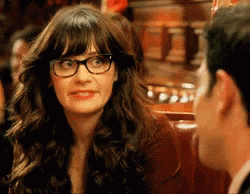 Uncomfortable Smile Of Zooey Deschanel GIF