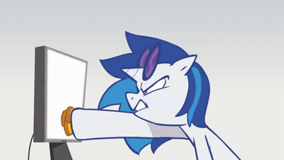 Unicorn Eating Cookie In Front Of Computer GIF