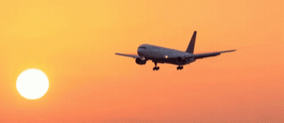 United Airlines Plane Flying In Sunset GIF