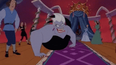 Ursula From The Little Mermaid Is Sitting On A Purple Carpet In Front Of A Crowd Of People . GIF