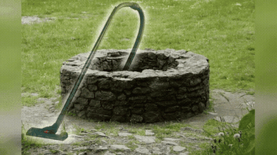 Vacuum Cleaner In Front Of Stone Well GIF