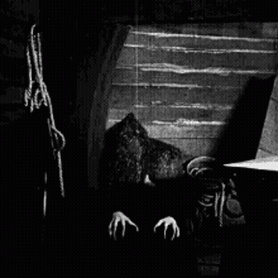 Vampire With Claws In Dark Room GIF