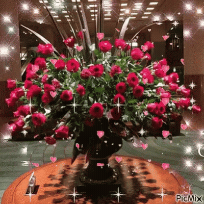 Vase Of Red Roses On Wooden Table GIF