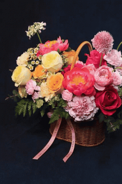 Vase With Yellow And Blue Flowers Against Dark Blue Background GIF