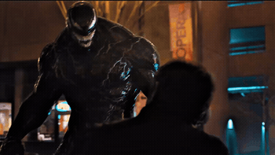 Venom Statue In Front Of Hot Sign GIF