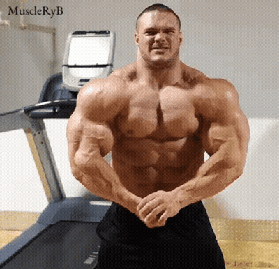 Very Muscular Man Standing In Front Of Treadmill GIF