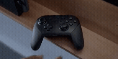 Video Game Controller On Wooden Shelf GIF