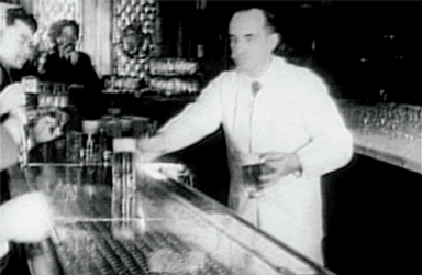 Vintage Bartender Offering Drinks GIF
