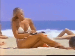 Vintage Sexy Woman On Beach Rubbing Lotion GIF