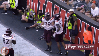 Virginia Tech Football Player Hugged By Two Teammates GIF