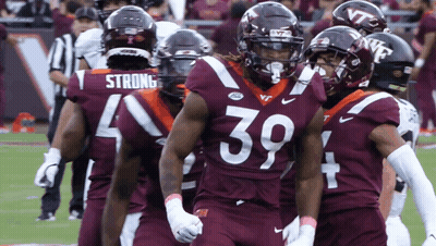 Virginia Tech Football Players Standing On Field GIF