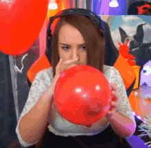 Vlogger Blowing Orange Birthday Balloons  GIF