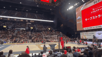 Volleyball Game in Front of Screen Saying All the Stars All the Fans