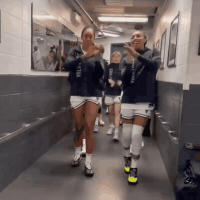 Volleyball Players Walking Down Hallway One Wearing Valley Hoodie GIF