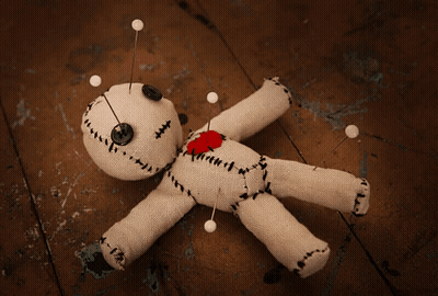 Voodoo Doll With Pins And Heart On Chest GIF