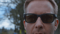 Walking Guy Taking Off His Shades GIF