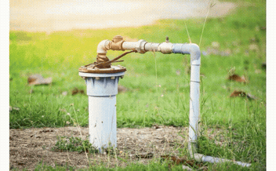 Water Pump Sitting In Grass Next To Hose GIF