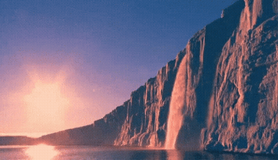 Waterfall Cliff Into Lake At Sunset GIF