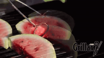 Watermelon Slices Are Being Cooked On A Grill With Grillax.com Written On The Bottom Right GIF