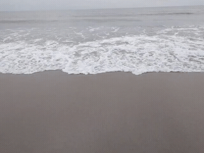 Waves Crashing On Sandy Beach With Foam GIF
