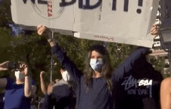 We Did It Joe People Holding Placard GIF