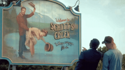 Welcome To Schitt's Creek Sign With Painting GIF