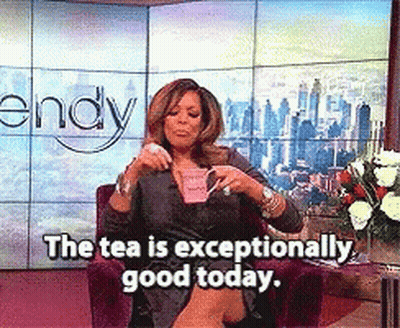 Wendy Williams Is Sitting In A Chair Drinking A Cup Of Tea GIF