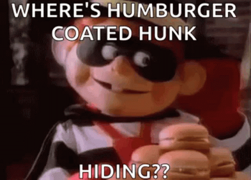 Where 'S Hamburger Coated Hunk Hiding ? A Cartoon Character Is Holding A Hamburger In His Hands . GIF