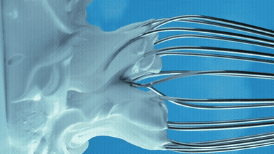 Whipped Cream Being Whisked On Blue Surface GIF