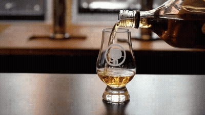 Whiskey Poured Into Skull Glass GIF