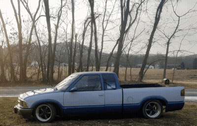 White And Blue Truck Parked In Field GIF