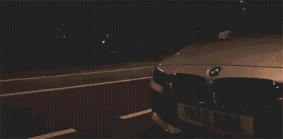 White BMW Parked In Dark Parking Lot GIF