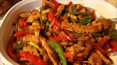White Bowl Filled With Chicken Peppers And Onions GIF
