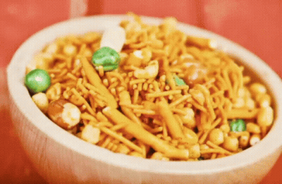 White Bowl Filled With Nuts And Noodles GIF