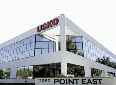 White Building With Point East Sign GIF