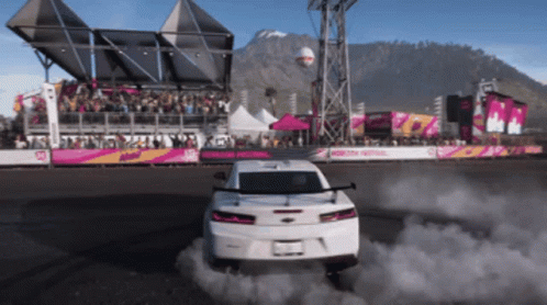 White Car Drifting In Front Of Crowd At Motorsport Festival GIF
