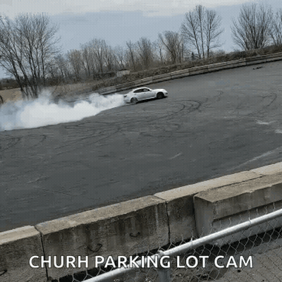 White Car Drifting With Smoke Church Parking Lot Cam GIF