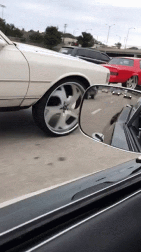 White Car Driving Down Highway With Red Car GIF