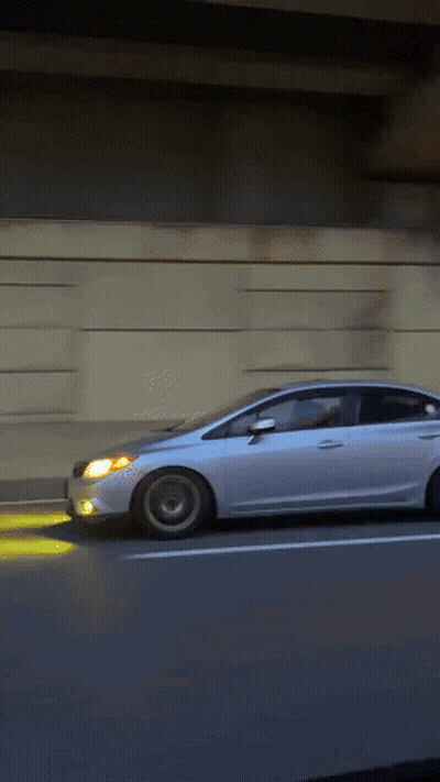 White Car Driving On Highway With Headlights On GIF