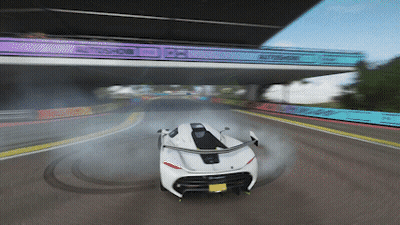 White Car Driving Under Bridge Saying Autoshow GIF