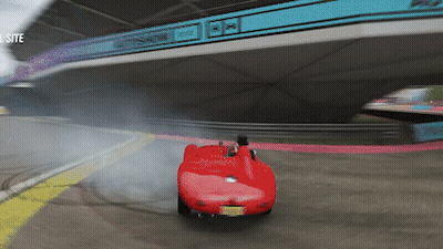 White Car Driving Under Bridge With Autoshow Sign GIF