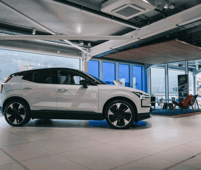 White Car In Showroom Saying Enjoy Is Here GIF